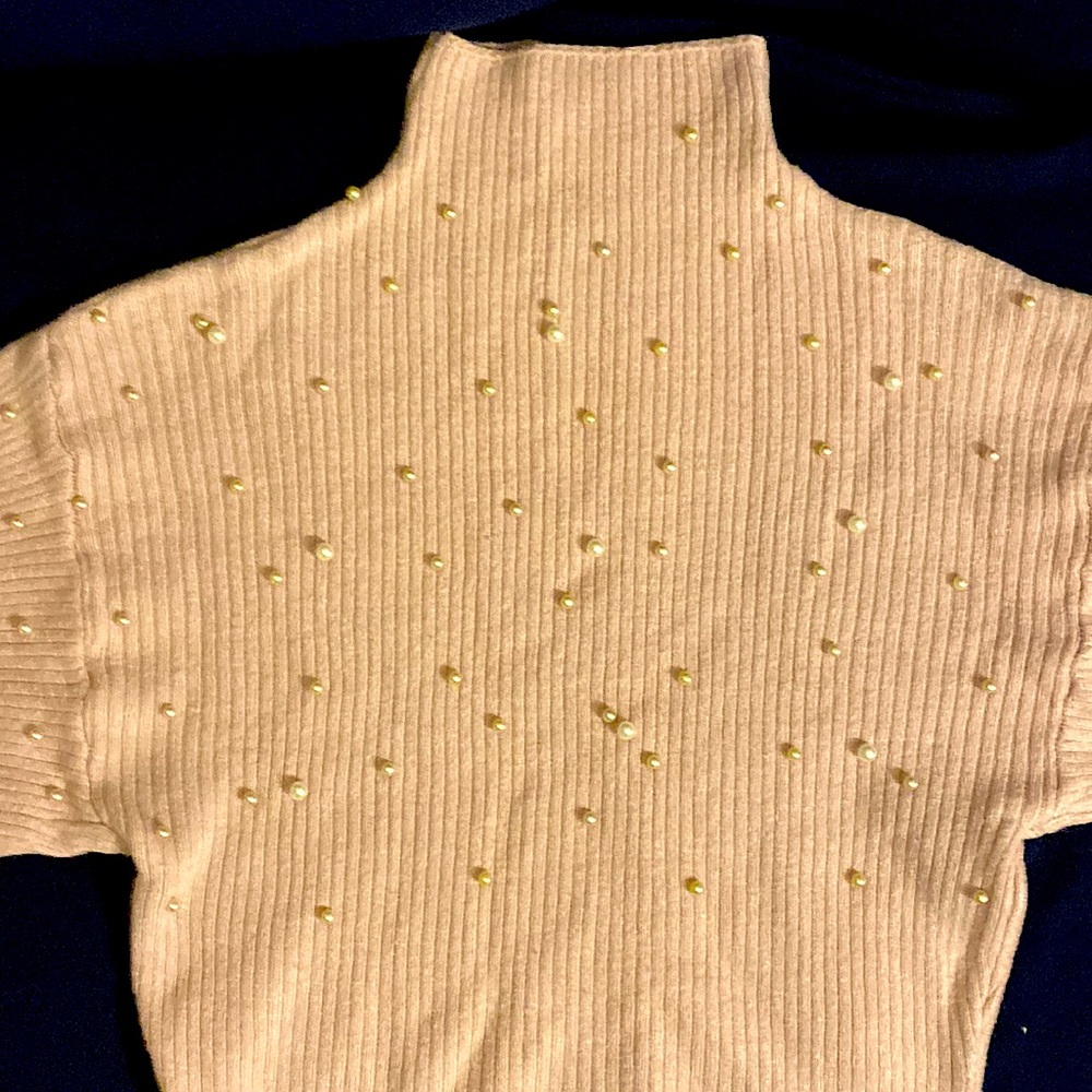 A gently used turtleneck blouse. Can be worn with dark colored jeans and boots.